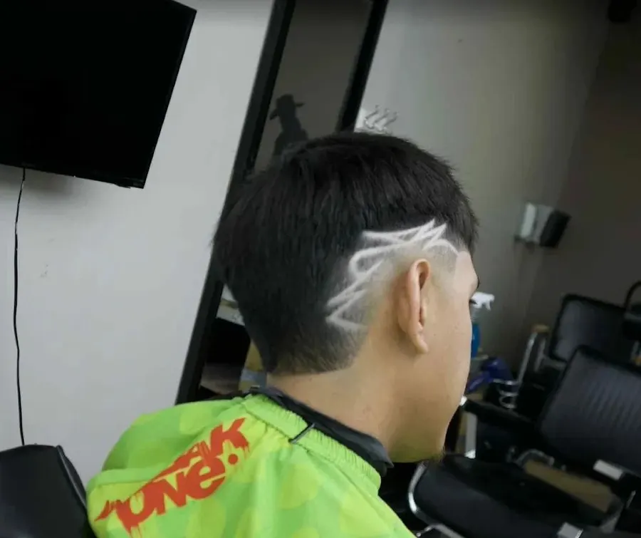 Skin fade with a freehand design, cut at Saloon Cuts